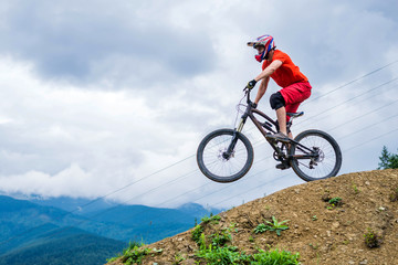 Naklejka na ściany i meble Professional athlete ride on a mountain bike.