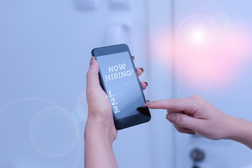Handwriting text Now Hiring. Conceptual photo finding evaluating working relationship with future employees woman using smartphone office supplies technological devices inside home