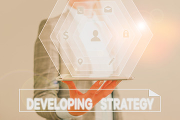 Conceptual hand writing showing Developing Strategy. Concept meaning Game plan that sets specific...
