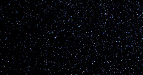 Flying dust particles on a black background