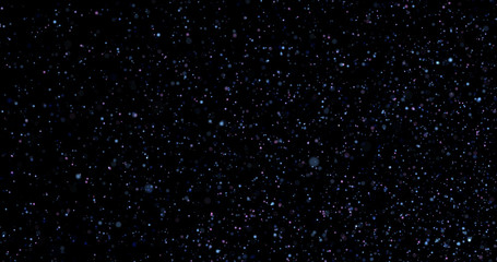 Flying dust particles on a black background