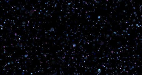 Flying dust particles on a black background