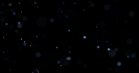 Flying dust particles on a black background