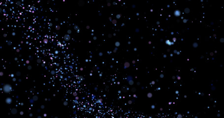Flying dust particles on a black background