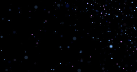 Flying dust particles on a black background