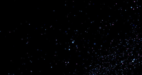 Flying dust particles on a black background