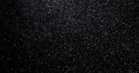 Natural white winter snowfall on a black background
