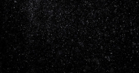 Natural white winter snowfall on a black background
