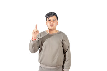Portrait of fatty boy with finger pointed up isolated on white background.