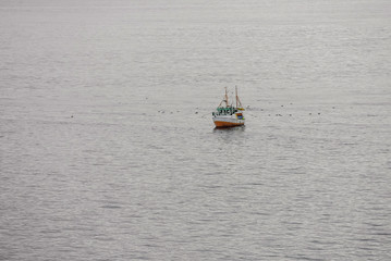 aerial view of a small trawler in the fjords