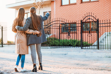 Young lesbian couple near their new house