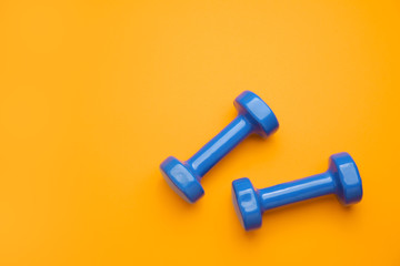 New dumbbells on color background