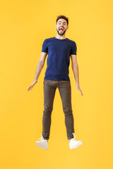 Fototapeta premium Jumping young man on color background