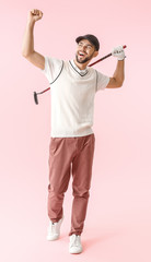 Handsome happy male golfer on color background