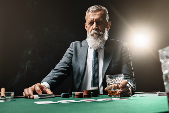 Mature businessman playing in casino