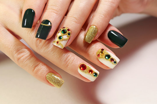 New year's fashionable beautiful festive manicure on short square nails with green lacquer color, with Golden sequins, bouillon and rhinestones of different colors .Christmas nail art. Stock Photo | Adobe Stock New year's fashionable beautiful festive manicure on short square nails with green lacquer color, with Golden sequins, bouillon and rhinestones of different colors .Christmas nail art. Stock Photo | Adobe Stock
