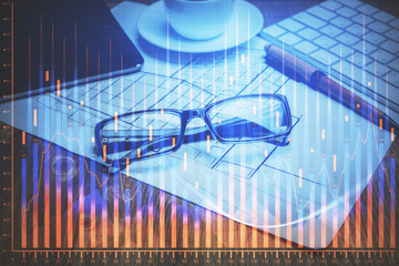 Financial chart hologram with glasses on the table background. Concept of business. Double exposure.