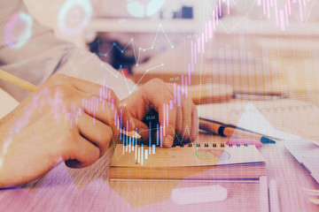 Multi exposure closeup hands with stock market forex graph.