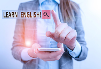 Word writing text Learn English. Business photo showcasing gain acquire knowledge in new language by study Business concept with mobile phone and business woman