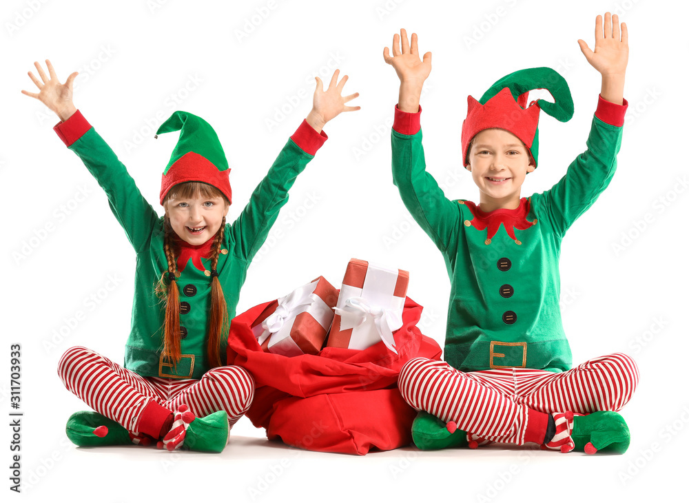 Sticker Little children in costume of elf and with Santa Claus bag full of gifts on white background