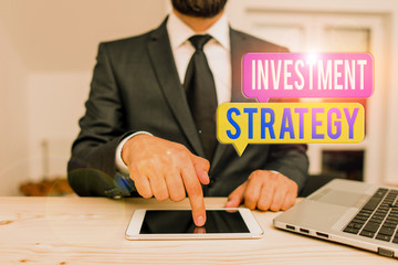 Word writing text Investment Strategy. Business photo showcasing the systematic plan to allocate investable assets Male human wear formal clothes present presentation use hi tech smartphone