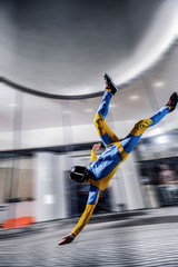 Hobbies. Free people prefere active sports. Bird men conquers sky. Flying people in blue and yellow suit. Extreme as a hobby.
