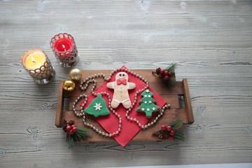 Plate with tasty Christmas cookies on wooden table