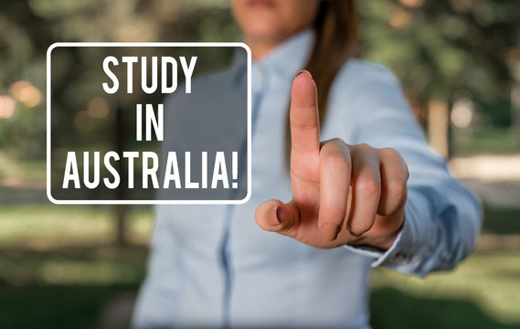 Handwriting text writing Study In Australia. Conceptual photo going into foreign country order complete your studies Woman in a blue business shirts pointing with her finger into empty space