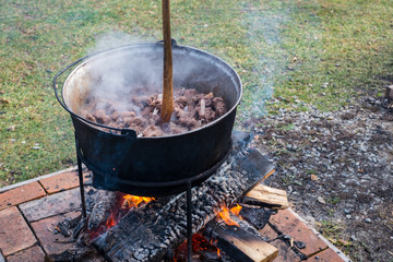 Romanian traditional food prepared at the cauldron on the open fire with wood, Christmas tradition