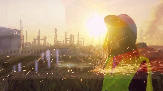 Double exposure of   Industrial Engineer and welder welding with Oil-Refinery  .Concept for industry and construction , 4k footage for your work.