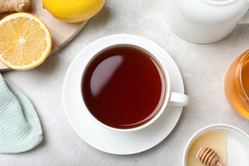 Fototapeta na wymiar Flat lay composition of tea with honey on light grey marble table