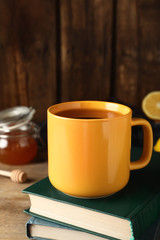 Delicious tea with honey on wooden table