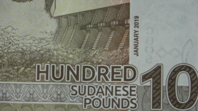 Close-up of the inscription with the value of 100 Sudanese pounds on an African banknote