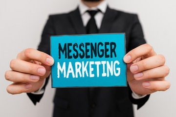 Writing note showing Messenger Marketing. Business concept for act of marketing to your customers using a messaging app Male human wear formal work suit with office look hold book