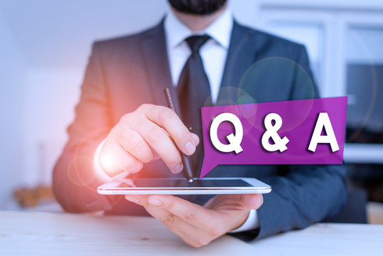Text sign showing Q And A. Business photo showcasing in which demonstrating asks questions and another one answers them Male human wear formal clothes present presentation use hi tech smartphone