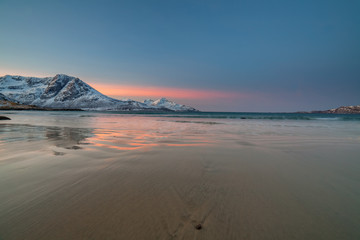 Amazing sunrise with amazing magenta color over sand beach. Tromso, Norway . Polar night. long shutter speed