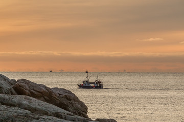 fishing boat with amazing sunset in background in lofoten, norway. © Tatiana