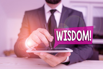 Text sign showing Wisdom. Business photo showcasing quality having experience knowledge and good judgement something Male human wear formal clothes present presentation use hi tech smartphone