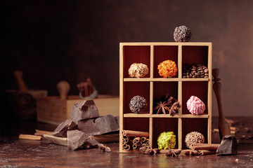 Chocolate truffles with broken pieces of chocolate and spices.