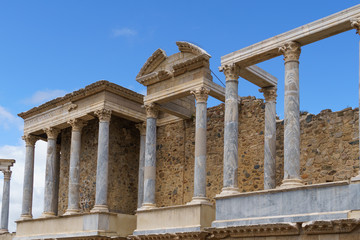 Obraz premium Scaenae frons in the Antique Roman Theatre in Merida. Panorama image. The Archaeological Ensemble of Merida is declared a UNESCO World Heritage Site Ref 664. Orange and teal style