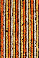 plastic flower garlands in vertical as backdrop for podium function event stage