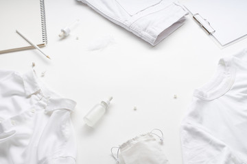 White monochromatic flatlay on white background. Clothes, accessories, stationery and beauty equipment. Blog design concept