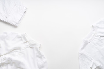 White monochromatic flatlay on white background with clothes. Blog design concept