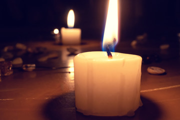 Large white lighted candle close-up. concept of magic, divination.