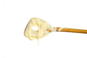 cake mixture on a wooden spoon, isolated on white background