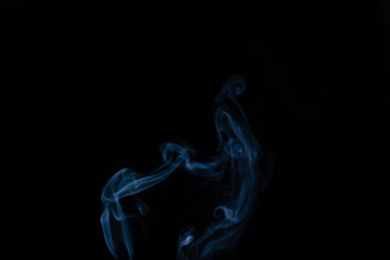 Beautiful abstract blue smoke with copy space on black background. Smoke background for art design or drawing. Abstract figure of the smoke