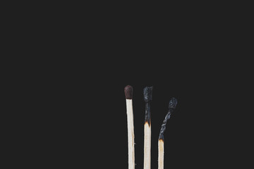 Match sticks over black background. Matte look and selective focus