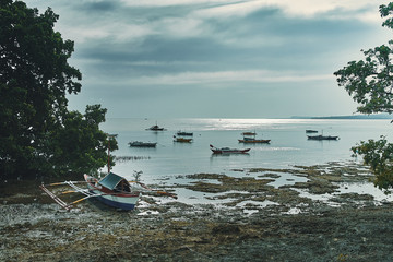 Fototapeta na wymiar blue sea landscape with fishing sailboats in the philippines