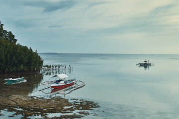 blue sea landscape with fishing sailboats in the philippines