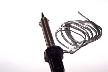 Soldering iron and solder on a white background